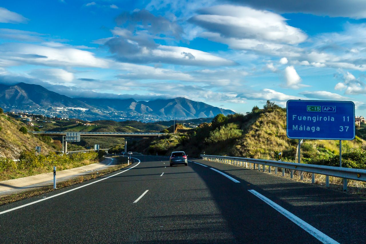 why-choose-us Beautiful view of AP-7 highway near Fuengirola and Málaga, with distant mountains under a blue sky.